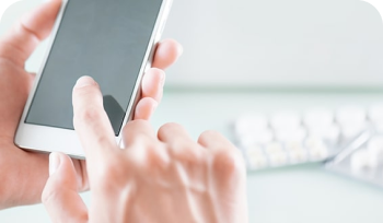 Hands using cell phone